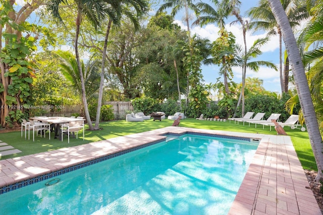 view of pool featuring a lawn