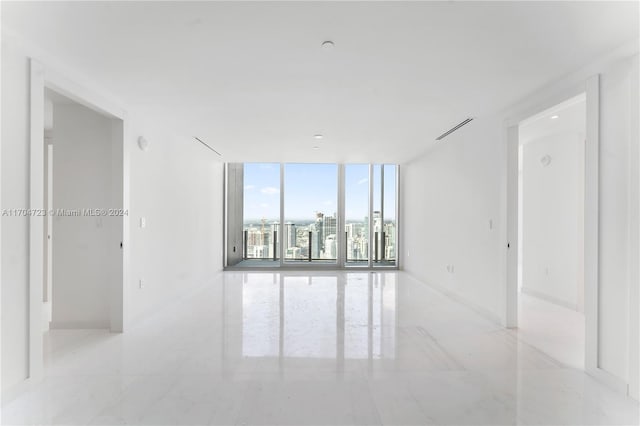 unfurnished room with floor to ceiling windows