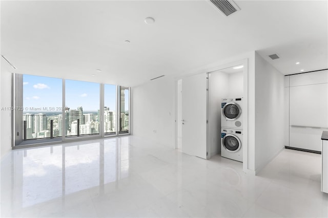 laundry area with stacked washer and clothes dryer