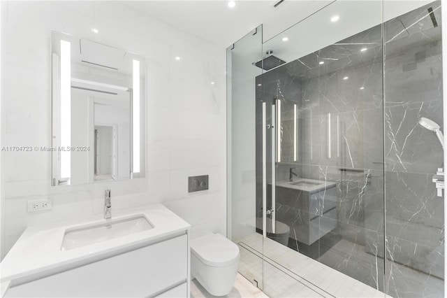 bathroom featuring vanity, toilet, tile walls, and a shower with shower door