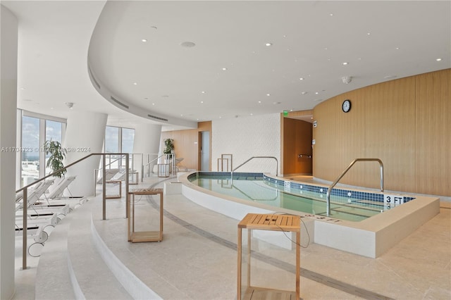 view of swimming pool with a jacuzzi