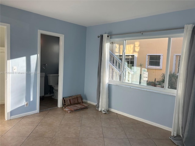 unfurnished room featuring tile patterned floors