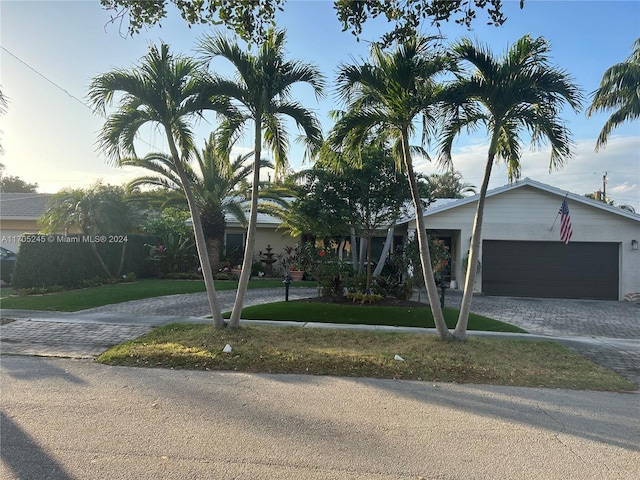 view of front of property featuring a yard and a garage