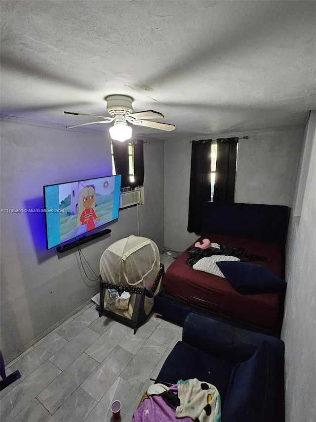 bedroom featuring ceiling fan and a textured ceiling