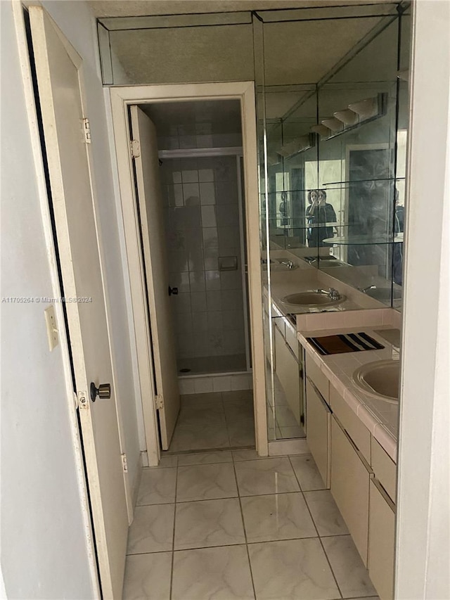 bathroom with vanity and a shower with door