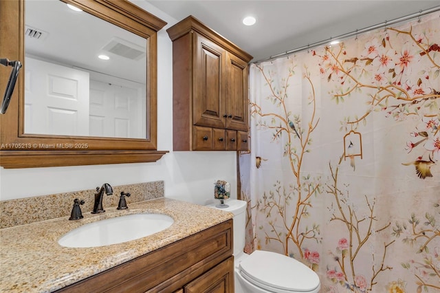 bathroom with toilet, vanity, visible vents, and recessed lighting