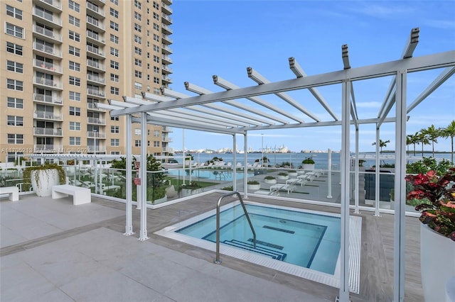 view of pool featuring a community hot tub, a pergola, and a water view