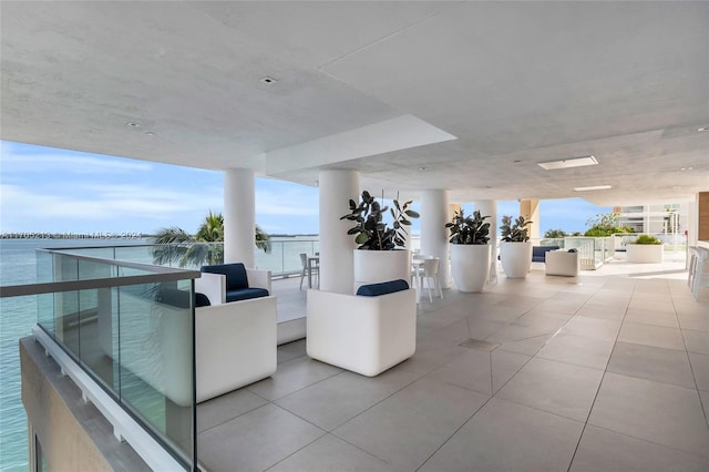 interior space with a water view and a balcony