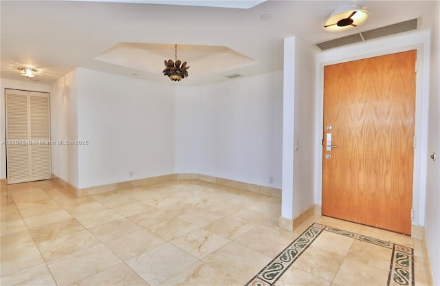 entryway with a tray ceiling