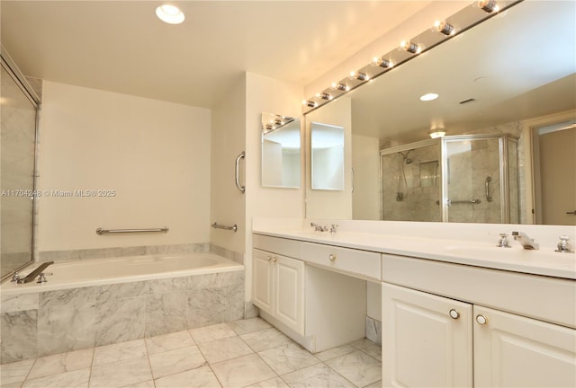 bathroom featuring vanity and independent shower and bath