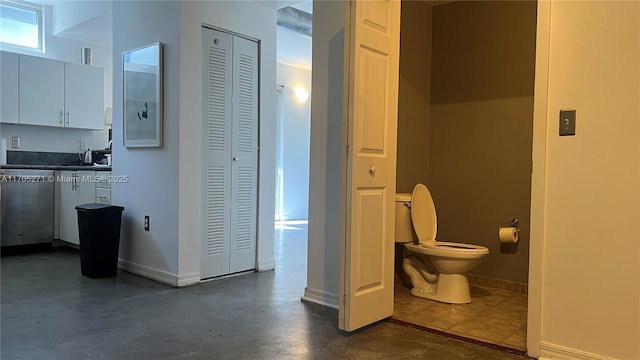 interior space featuring finished concrete flooring and baseboards