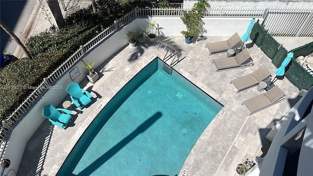 view of pool featuring a fenced backyard and an outdoor kitchen