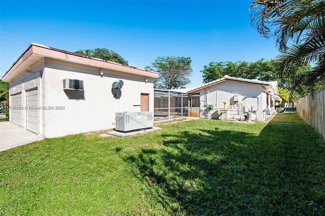 back of house featuring a yard, a pool, cooling unit, and a lanai