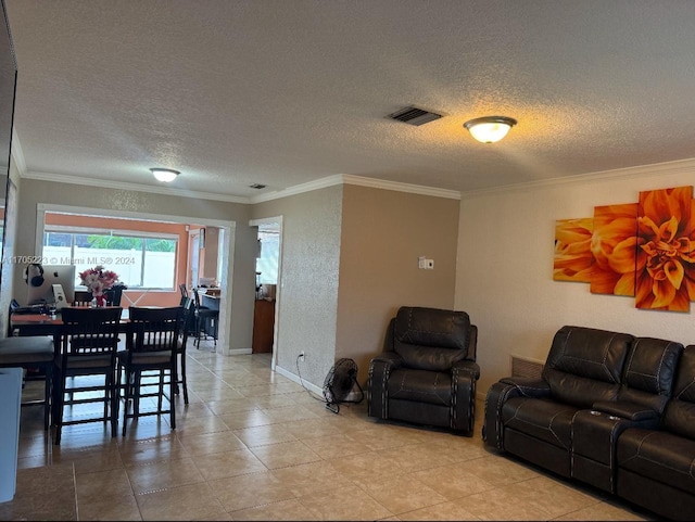 living room with light tile patterned flooring, crown molding, and a textured ceiling