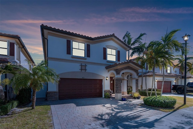 mediterranean / spanish home with a garage