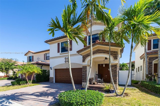 mediterranean / spanish home with a garage