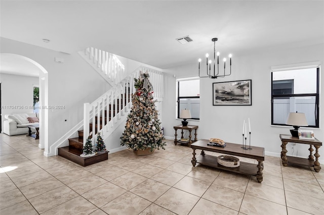 tiled living room featuring a chandelier