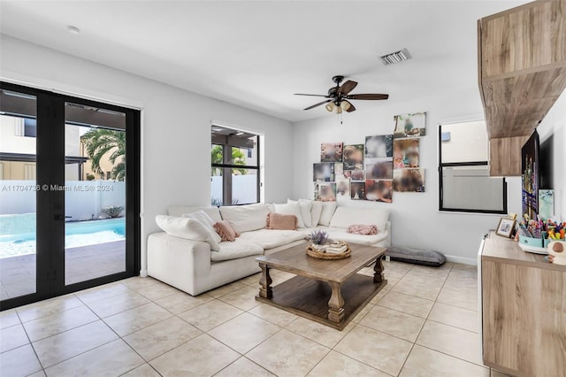 living room with ceiling fan, french doors, and light tile patterned floors