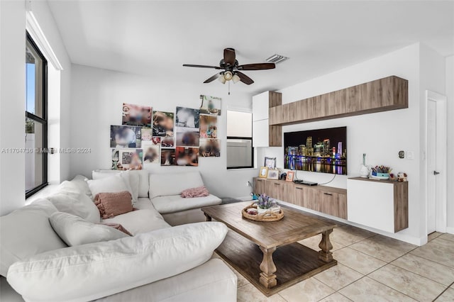 tiled living room with ceiling fan