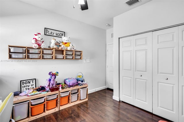 rec room with dark hardwood / wood-style floors and ceiling fan