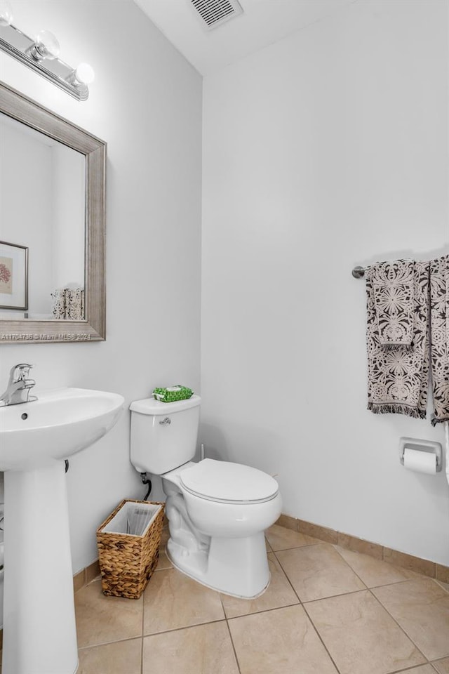 bathroom with tile patterned flooring, toilet, and sink