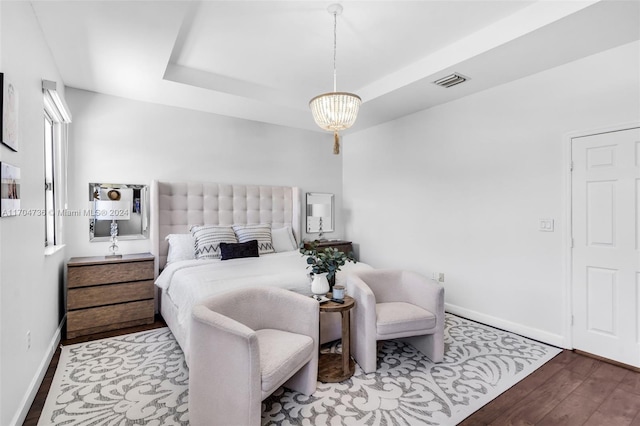 bedroom featuring hardwood / wood-style flooring and a chandelier