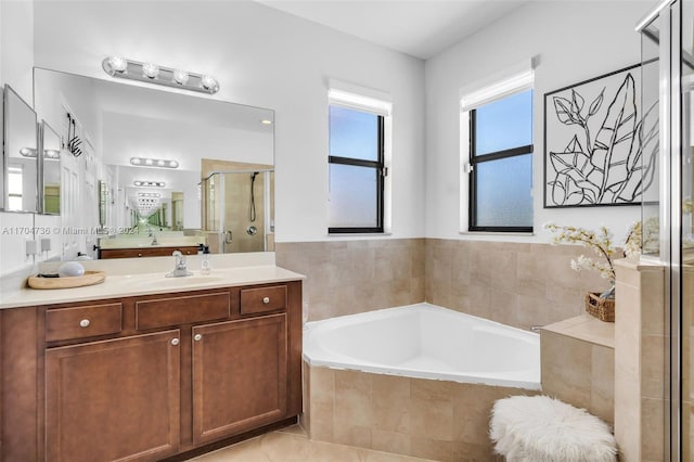 bathroom featuring tile patterned floors, vanity, and separate shower and tub