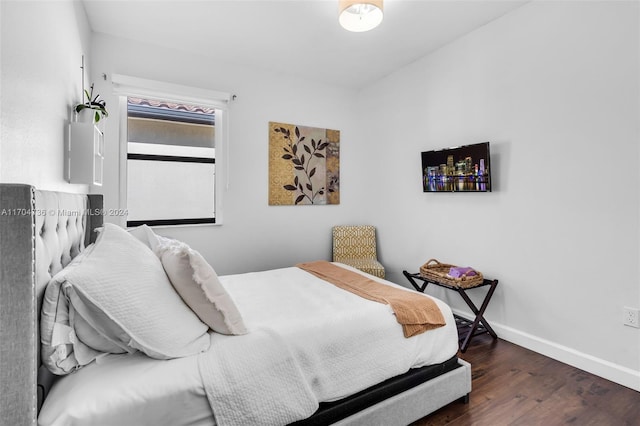 bedroom with dark wood-type flooring