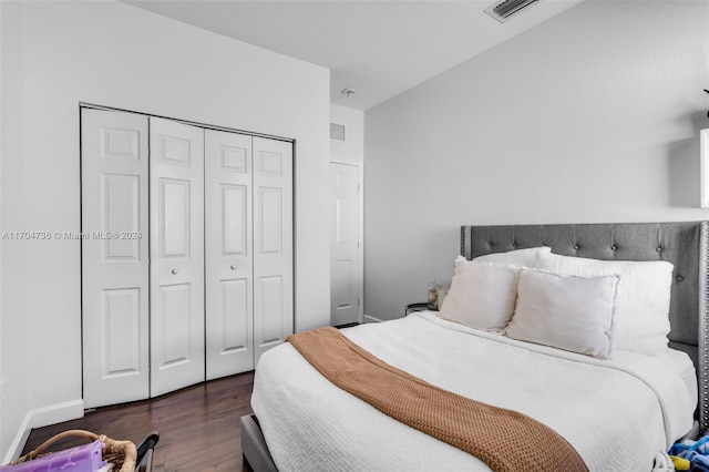 bedroom featuring dark hardwood / wood-style floors and a closet