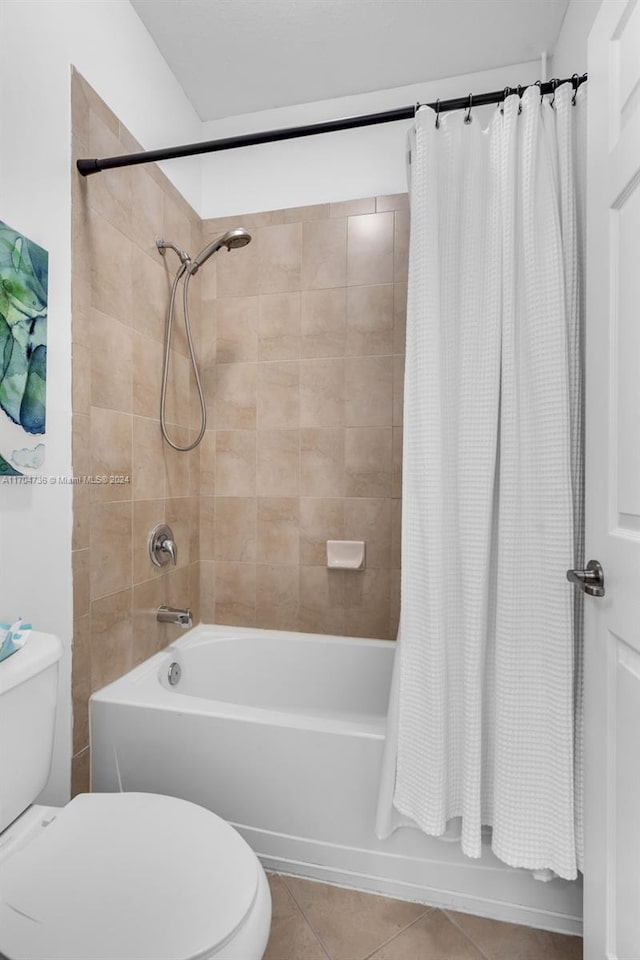 bathroom featuring tile patterned floors, shower / bath combo with shower curtain, and toilet