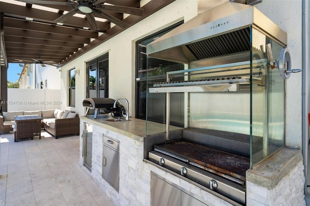 view of patio with an outdoor living space, sink, ceiling fan, and an outdoor kitchen