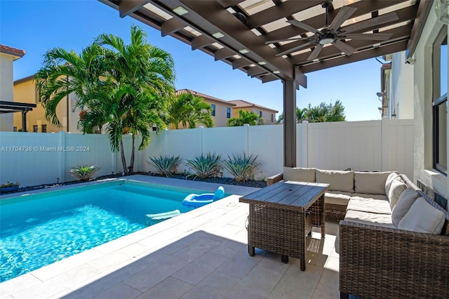 view of pool with outdoor lounge area, ceiling fan, a patio area, and a pergola