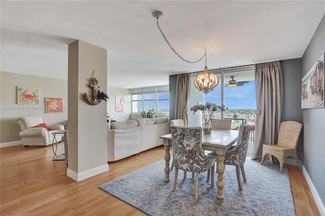 dining space featuring a notable chandelier and light hardwood / wood-style floors