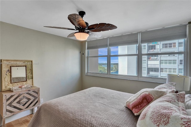 bedroom with hardwood / wood-style flooring and ceiling fan