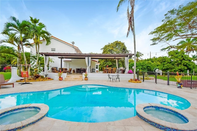 view of swimming pool featuring an in ground hot tub, a patio area, and a bar