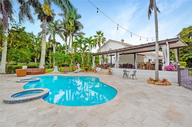 view of pool featuring an in ground hot tub, an outdoor hangout area, and a patio