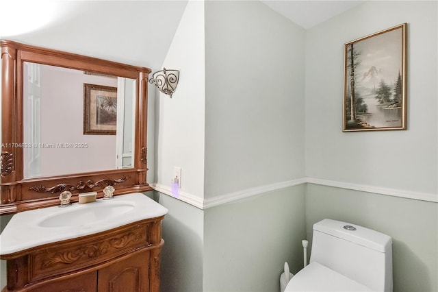 bathroom featuring vanity and toilet