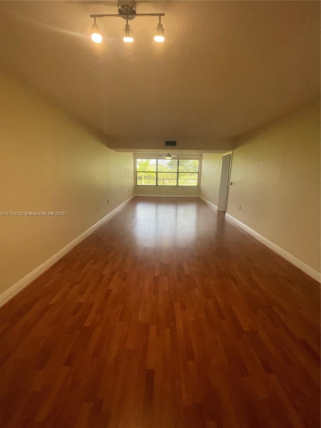 empty room with dark hardwood / wood-style floors