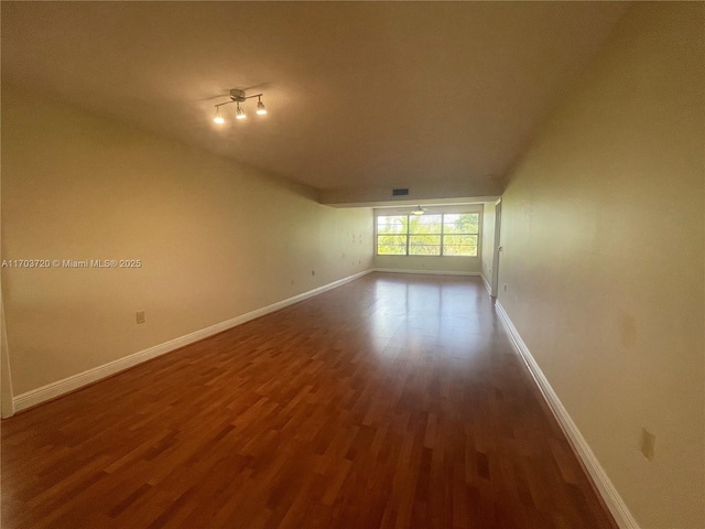 spare room featuring dark wood-type flooring