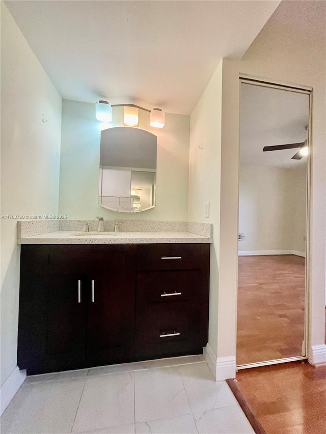 bathroom featuring ceiling fan and vanity