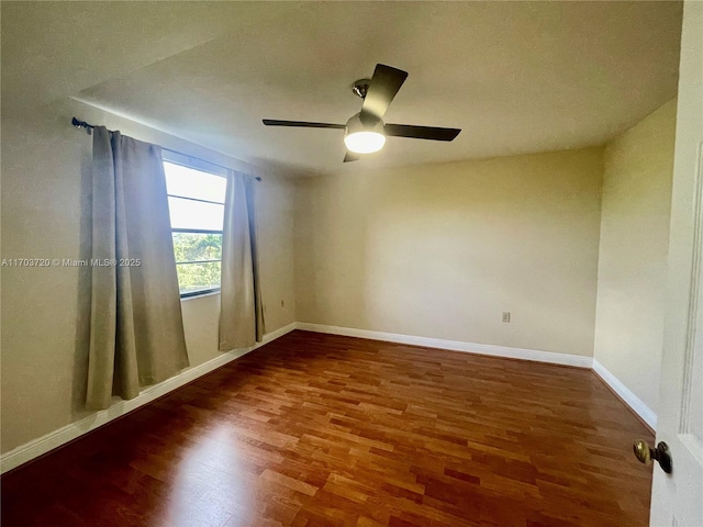 empty room with dark hardwood / wood-style floors and ceiling fan