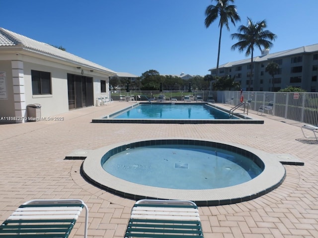 view of swimming pool with a community hot tub and a patio area