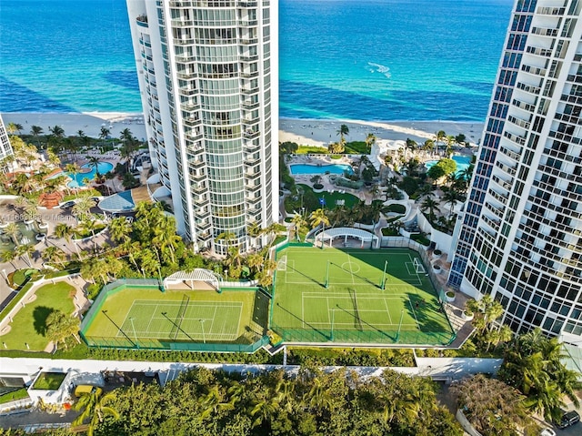 drone / aerial view featuring a water view and a view of the beach