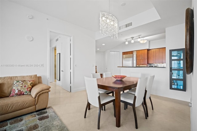 tiled dining room with an inviting chandelier