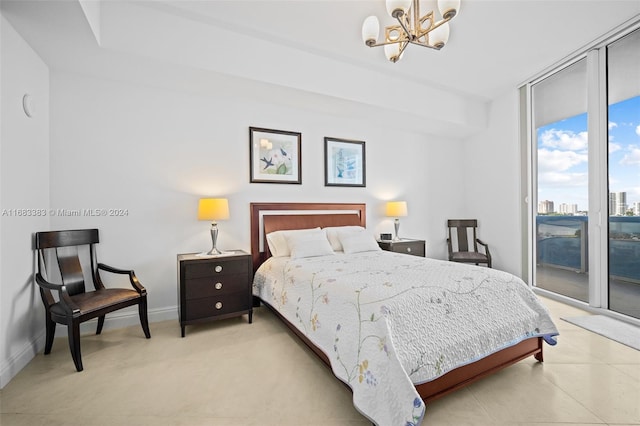 bedroom featuring access to exterior and an inviting chandelier