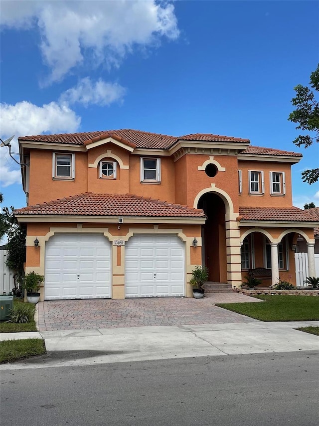 mediterranean / spanish-style home featuring a garage