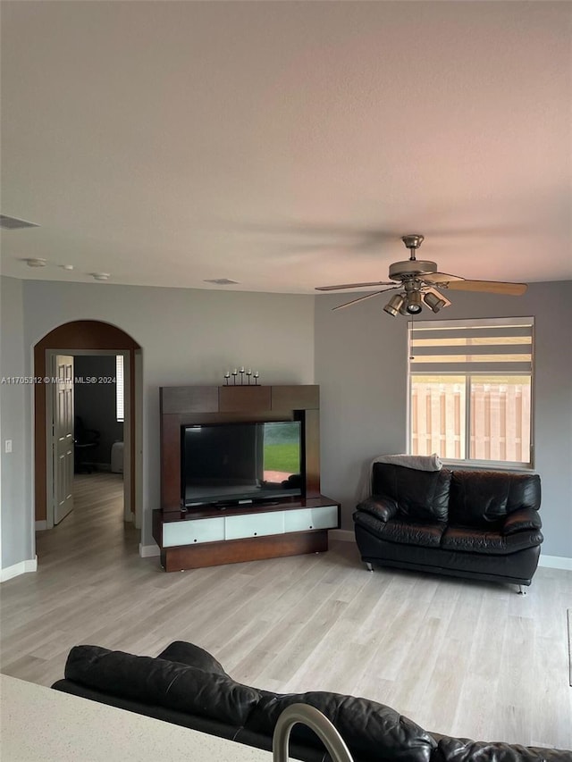 living room with ceiling fan and hardwood / wood-style flooring