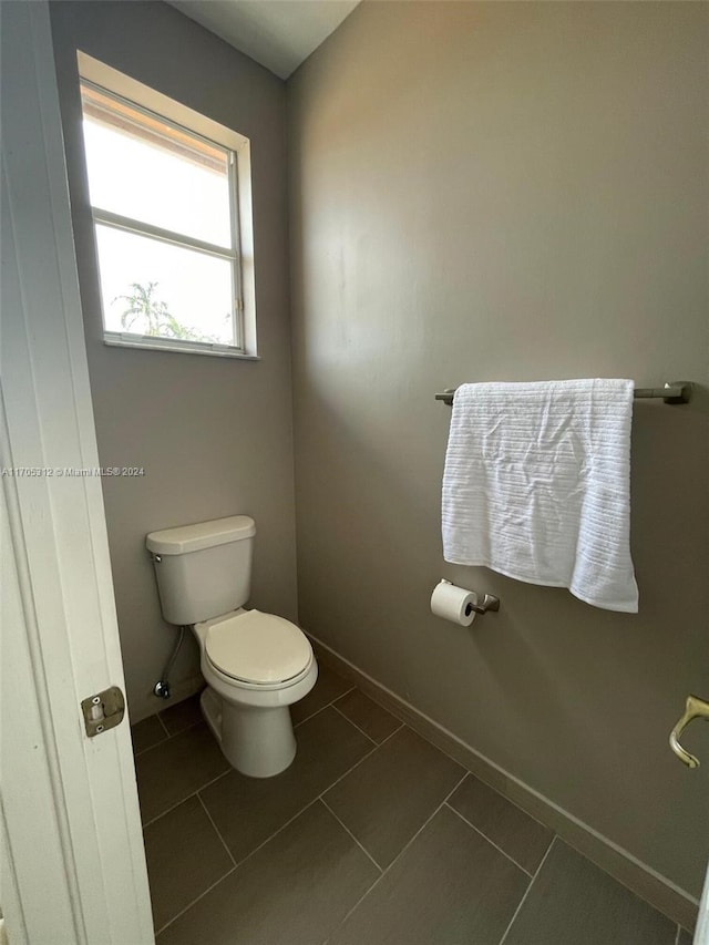 bathroom featuring tile patterned flooring and toilet