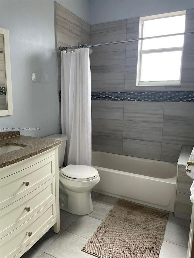 full bathroom with tile patterned flooring, shower / bath combo, toilet, and vanity