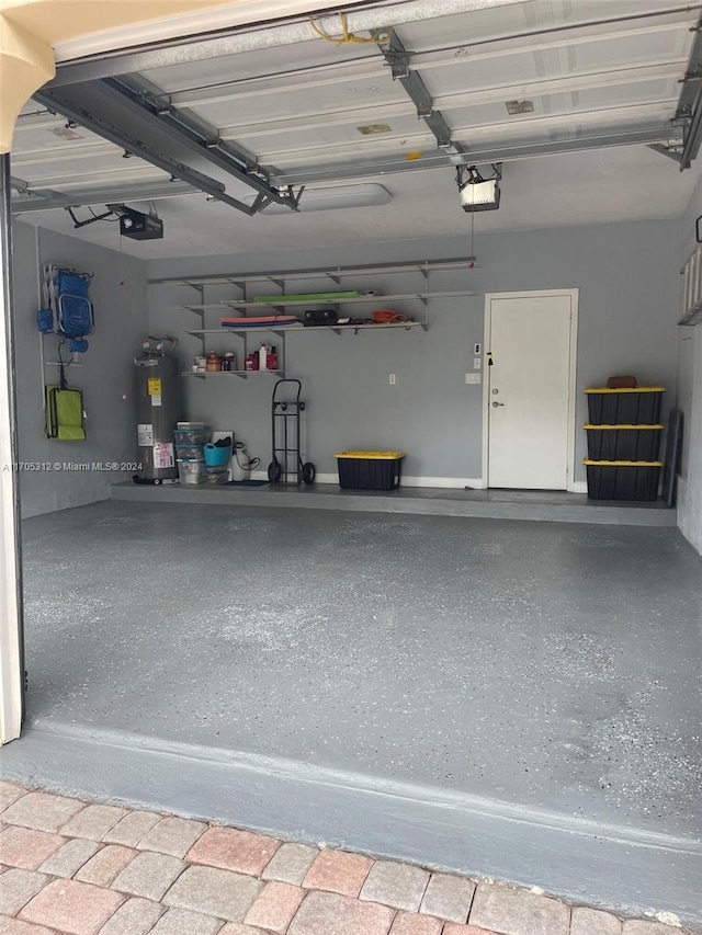 garage with electric water heater and a garage door opener